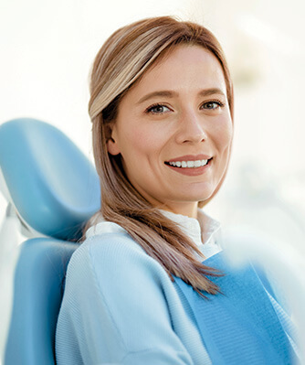 smiling woman sitting in a dental chair