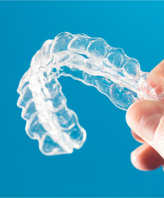 person holding a set of clear aligners